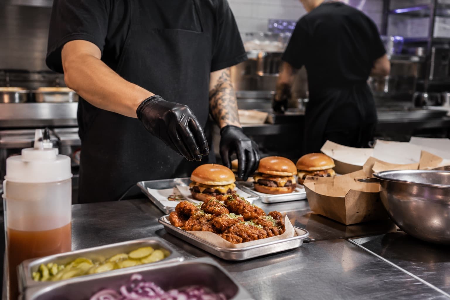 Chef assembling burgers in a delivery kitchen